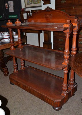 Lot 548 - A Victorian mahogany three tier buffet bearing label for the famous Irish cabinet makers,...