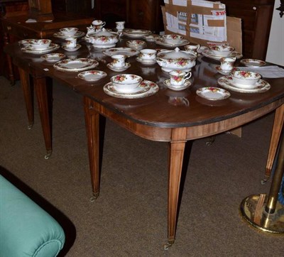 Lot 553 - A Georgian mahogany D-end dining table with extra leaf and clips