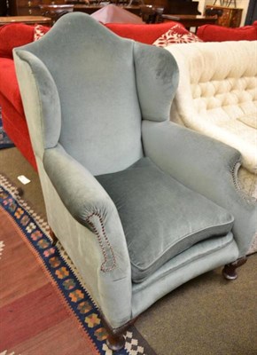 Lot 555 - A Georgian style wing armchair