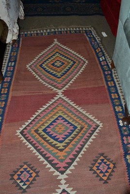 Lot 556 - Veramin Kilim Central Persia, the abrashed field with a column of polchrome stepped medallions...