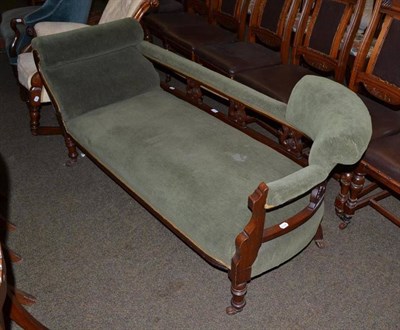 Lot 561 - A Victorian walnut framed chaise longue upholstered in green moquette