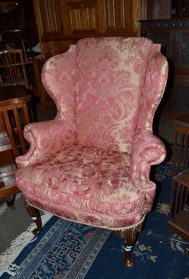 Lot 585 - A wingback armchair (pink covered)