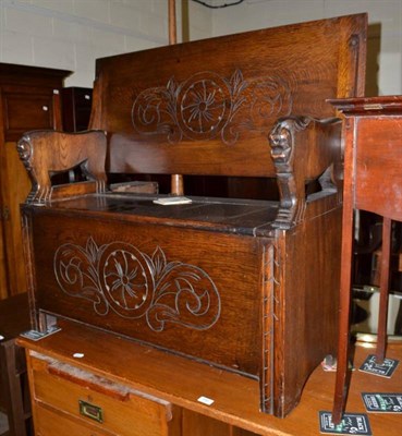 Lot 598 - A carved oak monk's bench and a standard lamp