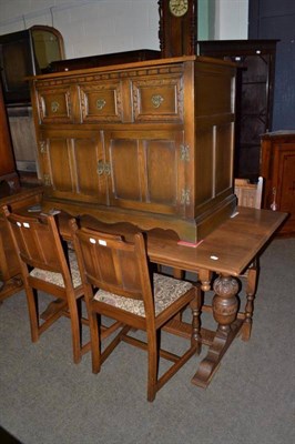 Lot 613 - A reproduction oak dining suite comprising an refectory table, four chairs, a side table and...