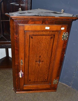 Lot 618 - An oak corner cupboard