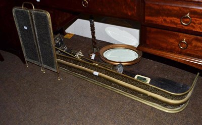 Lot 622 - A brass fender, a spark guard, a fire companion, a circular mirror and an oak table lamp