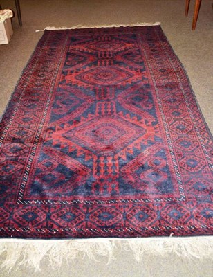 Lot 642 - Balouch rug West Afghanistan, the midnight blue field with a single column of stepped...