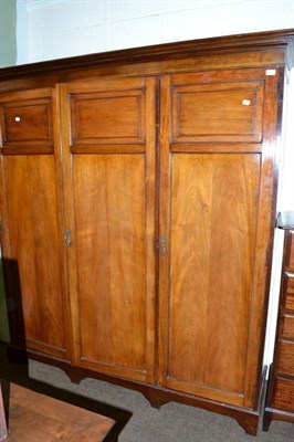 Lot 646 - An early 20th century oak combination triple wardrobe