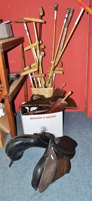 Lot 714 - Polo sticks, a leather saddle, riding boots etc