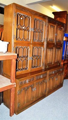 Lot 751 - A carved oak and linen fold glazed cabinet