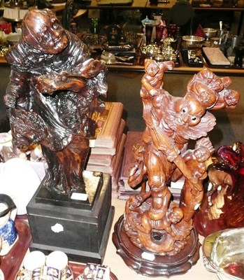 Lot 5 - Two Chinese figural wood carvings and a carved wood stand