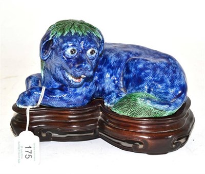 Lot 175 - A Chinese Porcelain Figure of a Recumbent Lion Dog, incised with naturalistic fur picked out in...