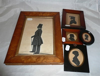 Lot 28 - A 19th century silhouette full length portrait of a gentleman in a birds eye maple frame, a...