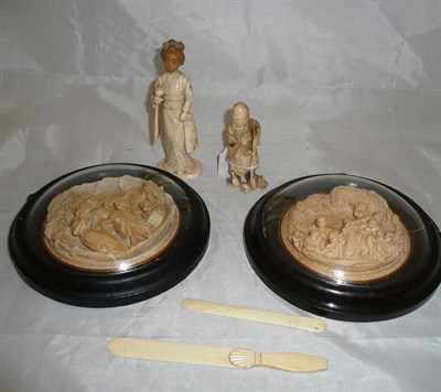 Lot 46 - A pair of relief decorated circular plaques depicting classical figures, two Japanese ivory figures