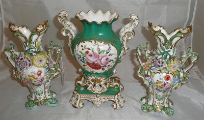 Lot 48 - A pair of Rockingham style flower encrusted vases and a green ground floral vase