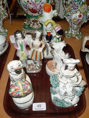 Lot 49 - A Staffordshire spill vase of a fox, a Staffordshire spaniel with basket, a shepherdess and two...
