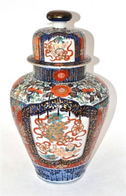 Lot 180 - An Imari Porcelain Vase, Meiji period, of fluted baluster form, typically painted with panels...
