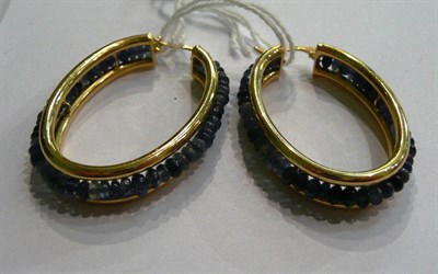 Lot 80 - A pair of 18ct gold hoop earrings with sapphire beads