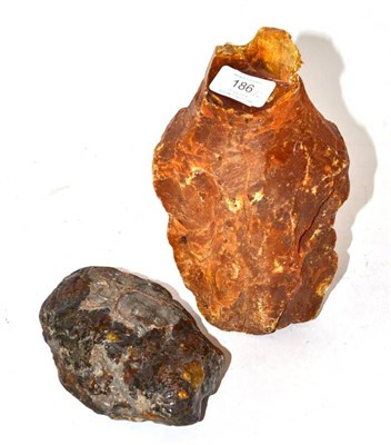 Lot 186 - An Amber Boulder, of dark orange tone, 15cm long; and A Copal Boulder, of mid orange tone, 21cm...