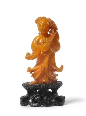 Lot 188 - A Chinese Amber Figure of Guanyin, probably late 18th or early 19th century, the standing...