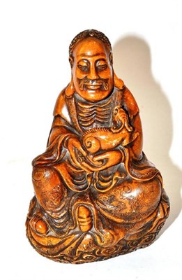 Lot 190 - A Chinese Soapstone Figure of Buddha, Qing Dynasty, the seated figure wearing flowing robes holding