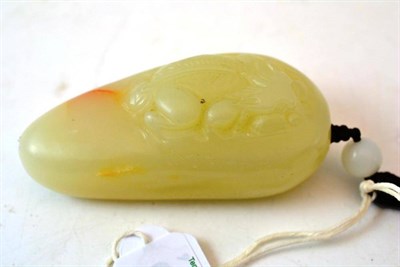 Lot 200 - A Chinese Pale Celadon Jade Pendant, of ovoid form, carved with a recumbent beast, 8.5cm long