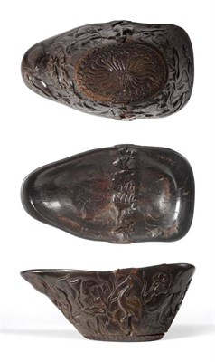 Lot 217 - A Chinese Rhinoceros Horn Libation Cup, Qing Dynasty, 18th century, of shaped oval form, the...