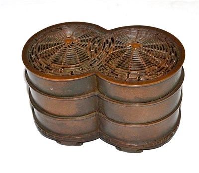Lot 225 - A Chinese Bronze Three-Tier Stacking Box, 19th century, formed as conjoined circles, the cover cast