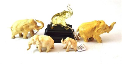 Lot 233 - A Group of Four Indian Ivory Figures of Elephants, late 19th century, each standing with trunks...