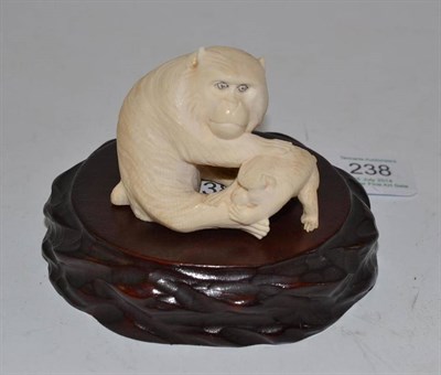 Lot 238 - A Japanese Ivory Okimono, Meiji period, as a seated monkey and infant, 4.5cm high, wooden stand