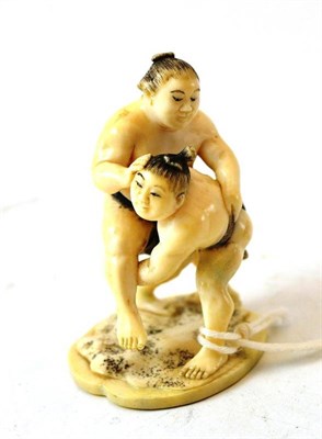 Lot 239 - A Japanese Ivory Okimono, signed Toshimitsu, Meiji period, as sumo wrestlers, on a shaped oval...