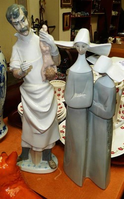 Lot 16 - Two Lladro figures, one as a male midwife