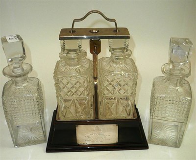 Lot 37 - A two bottle tantalus and a pair of decanters (3)