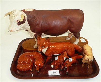 Lot 38 - Four various Beswick foxes, Beswick Hereford bull on wood plinth and Highland calf