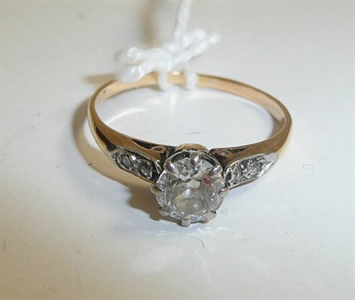 Lot 51 - A diamond solitaire ring with stone set shoulders