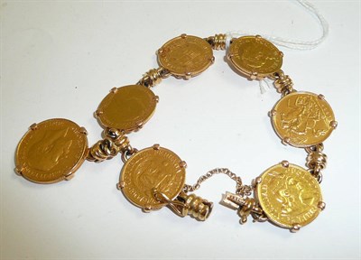 Lot 58 - A coin bracelet hung with a 1911 full sovereign and assorted other coins including four 1/2 Libras