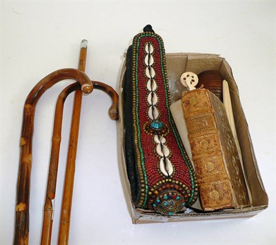 Lot 124 - Two walking sticks, a yard stick, Georgian newspapers, leather bound volume, bead work and seashell