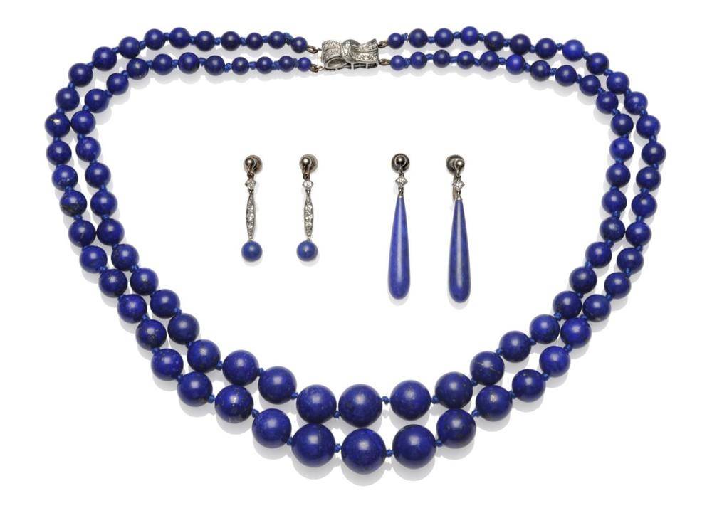 Lot 280 - A Lapis Lazuli Necklace with a Diamond Set Clasp, two knotted rows of graduated spherical beads...
