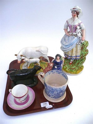 Lot 198 - Three Staffordshire figures, cow creamer, blue and white mug and a Kirby Stephen cup and saucer