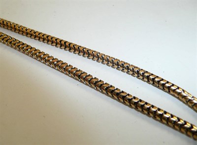 Lot 210 - A guard chain, stamped '15ct'