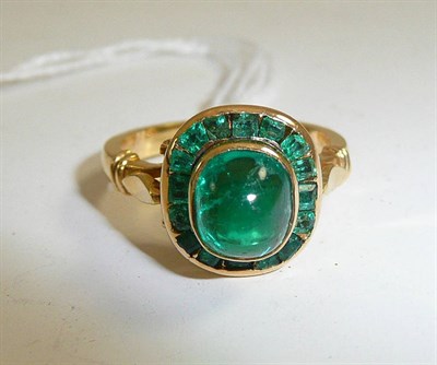 Lot 220 - An 18ct gold ring set with emeralds