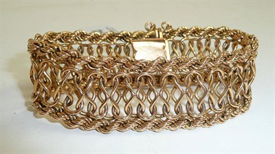 Lot 234 - A fancy link bracelet stamped '18k'