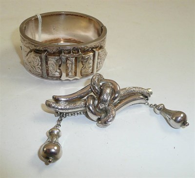 Lot 242 - A silver bangle and a silver brooch