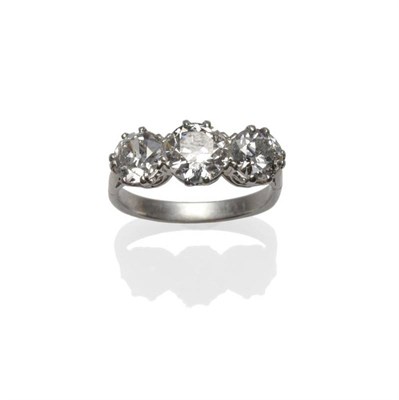 Lot 289 - A Diamond Three Stone Ring, the graduated old cut diamonds in white claw settings, to tapered...