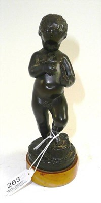 Lot 263 - A French bronze figure of cherub, circa 1900, standing, one foot on a basket, holding a bird...