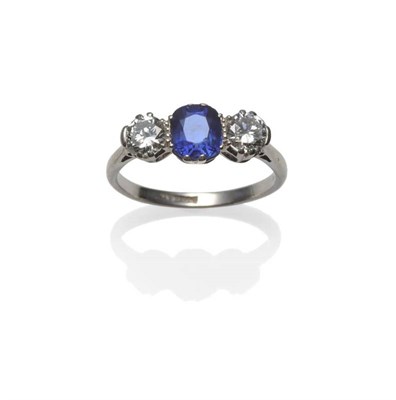 Lot 290 - A Sapphire and Diamond Three Stone Ring, the cushion mixed cut sapphire with an old brilliant...