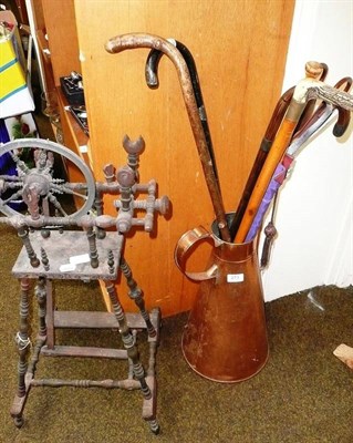 Lot 273 - A quantity of walking sticks, a copper measure jug and a wooden model of a spinning wheel