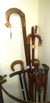 Lot 275 - A collection of walking sticks and a wicker butcher's basket