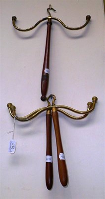 Lot 276 - Three brass and treen coat hangers