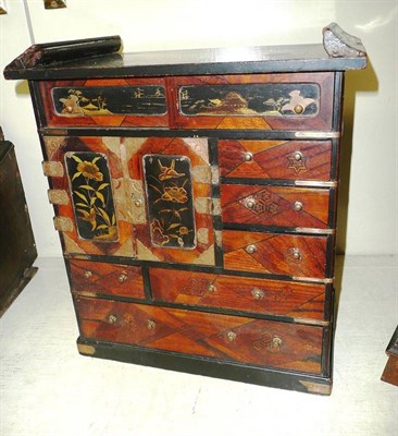 Lot 284 - A Japanese ash and stained wood miniature cabinet